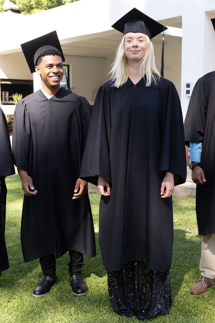 Diverse College Graduates in Caps and Gowns on Campus Lawn