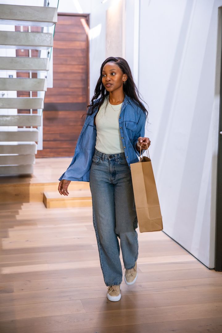 Woman in Modern Home Interior Casual Style Carrying Shopping Bag