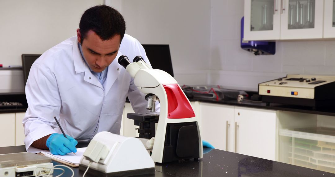 Scientist Analyzing Data in Laboratory with Microscope - Free Images, Stock Photos and Pictures on Pikwizard.com