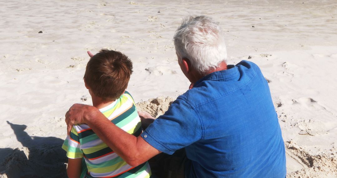 Grandfather and Grandson Sitting Together on Beach - Free Images, Stock Photos and Pictures on Pikwizard.com