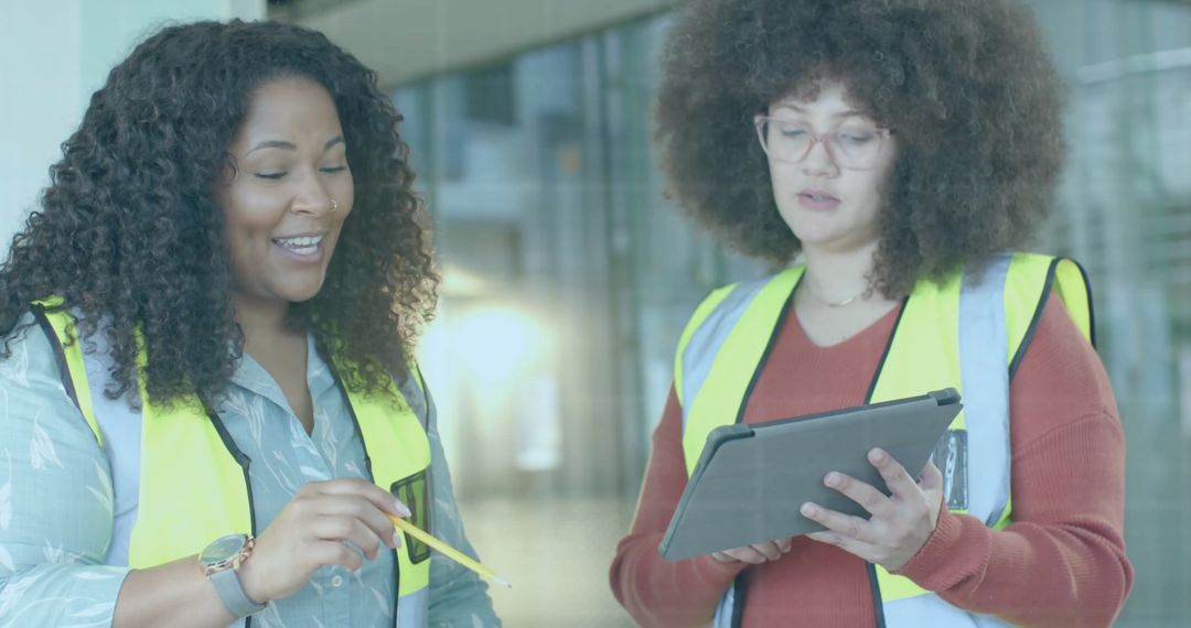 Diverse Female Engineers Analyzing Data on Tablet On Construction Site