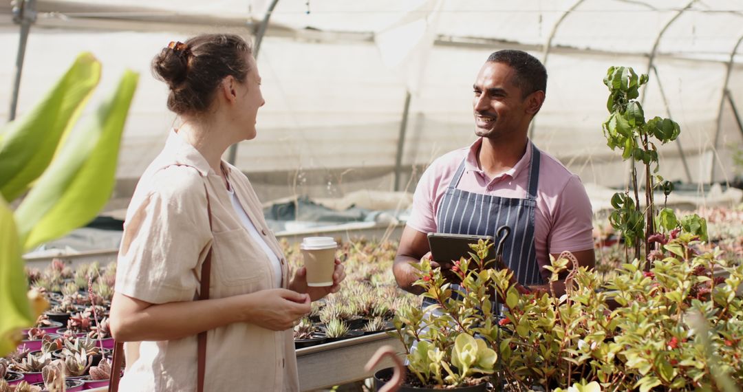 Diverse Vendor and Customer Discussing Succulents in Greenhouse