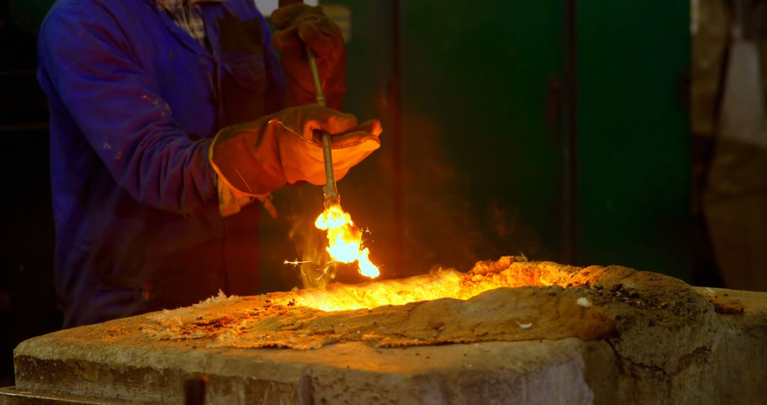 Metalworker Handling Molten Metal in Industrial Furnace - Free Images, Stock Photos and Pictures on Pikwizard.com