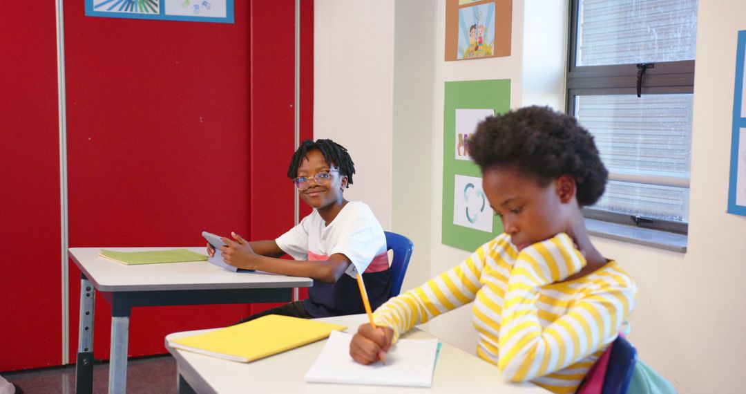 Engaged Students Learning Together in Bright Classroom Setting