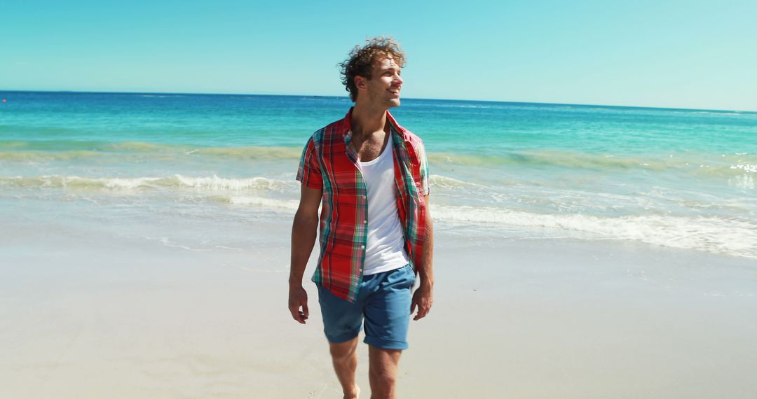 Man Walking on Beach with Blue Sea in Background - Free Images, Stock Photos and Pictures on Pikwizard.com