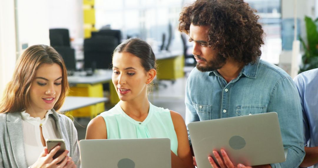 Business Team Collaborating with Technology Devices in Modern Office