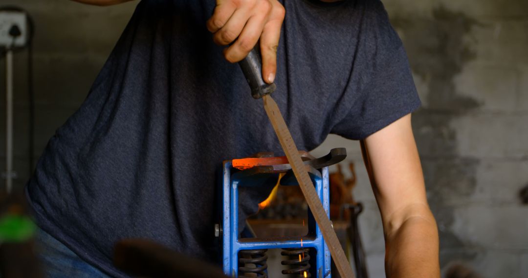 Close-Up of Blacksmith Shaping Metal with File in Workshop - Free Images, Stock Photos and Pictures on Pikwizard.com