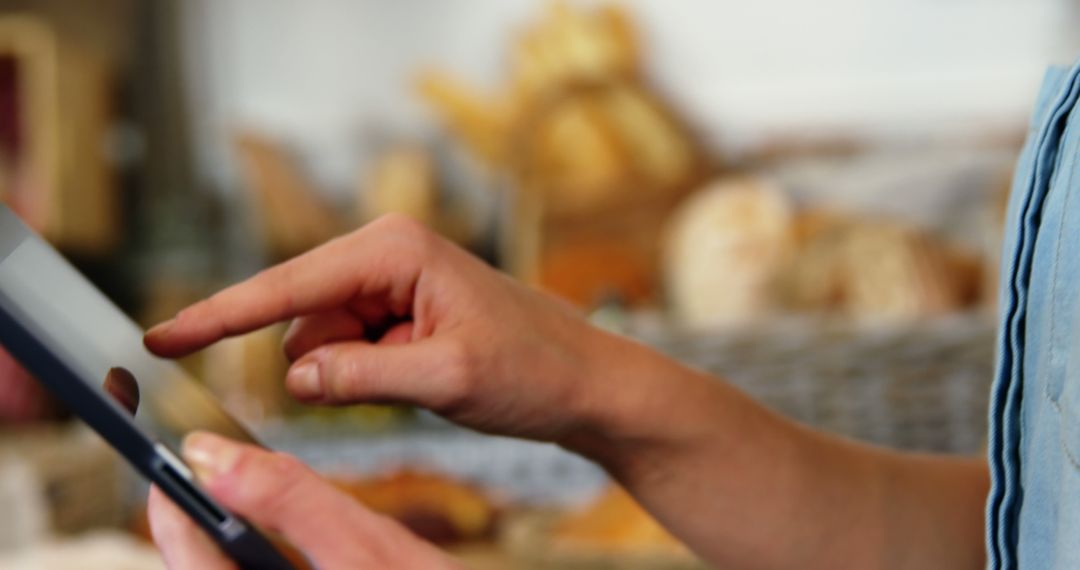 Close-Up of Person Using Tablet in Bakery - Free Images, Stock Photos and Pictures on Pikwizard.com