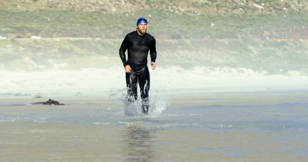 Triathlete Jogging on Beach during Sunny Day - Free Images, Stock Photos and Pictures on Pikwizard.com