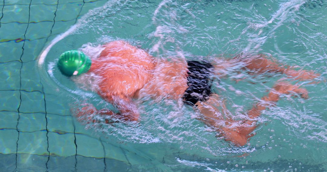 Man Swimming Underwater in Pool with Green Swim Cap - Free Images, Stock Photos and Pictures on Pikwizard.com