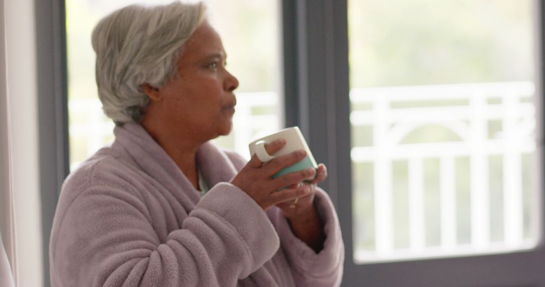 Elderly African American Woman Relaxing with Coffee at Home - Free Images, Stock Photos and Pictures on Pikwizard.com