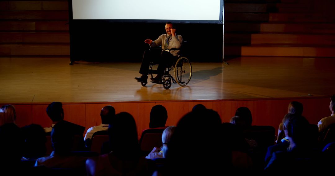 Disabled Businessman Presenting in Auditorium to Attentive Audience