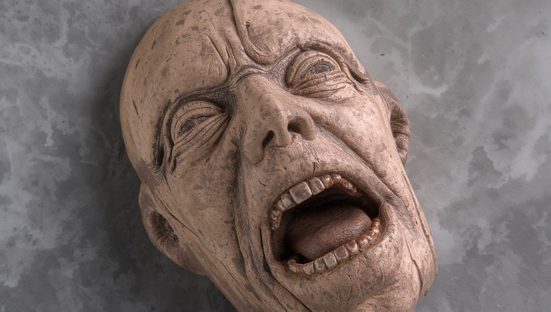 Sculpted Screaming Head Weathered Patina Close-Up for Horror Prop and Art Study