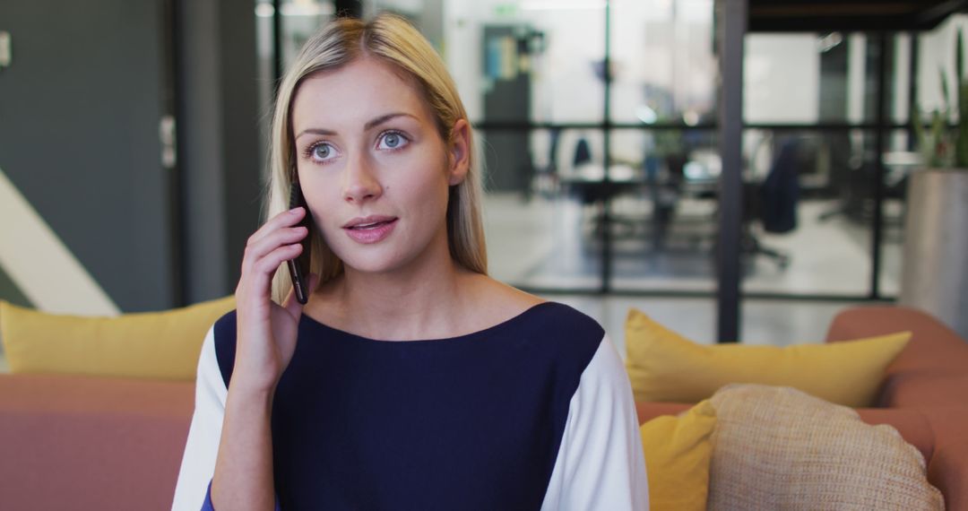 Businesswoman Discussing on Smartphone in Casual Office Space