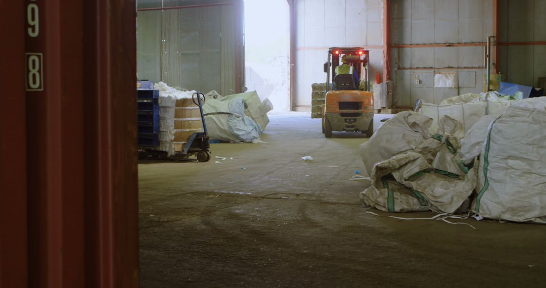 Forklift Operating in Industrial Warehouse with Random Stacked Items - Free Images, Stock Photos and Pictures on Pikwizard.com