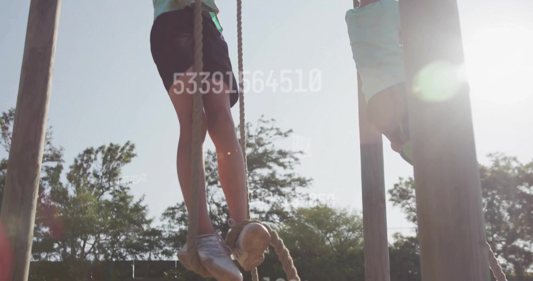 Boy Climbing Rope at Outdoor Playground with Number Overlay