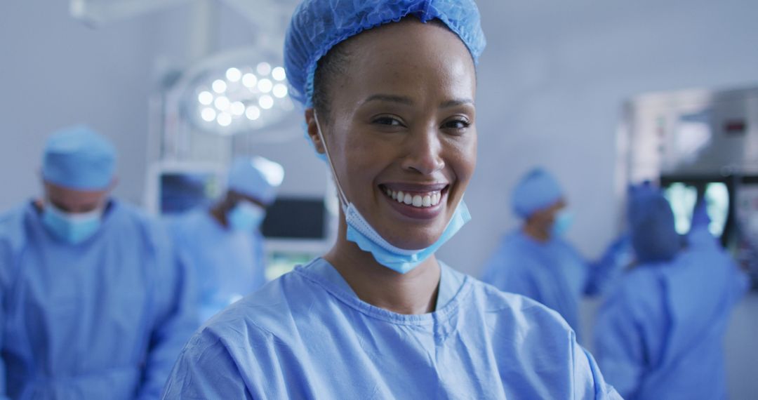 Smiling Surgeon in Operating Room with Team in Background - Free Images, Stock Photos and Pictures on Pikwizard.com