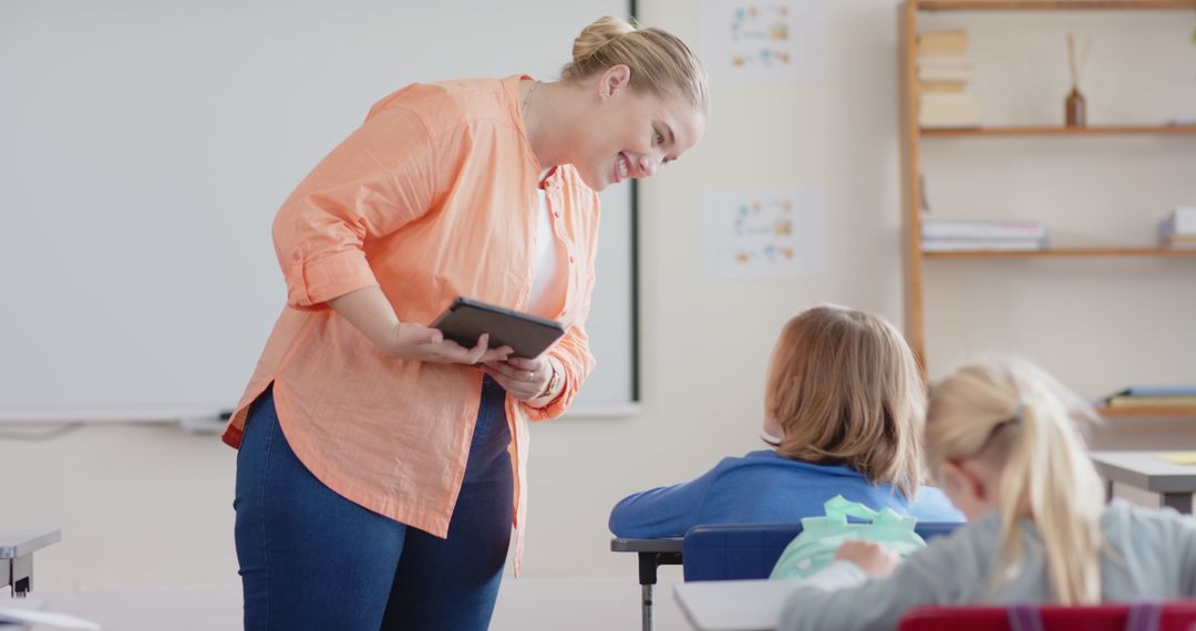 Teacher Engaging Student with Digital Learning Technology in Classroom