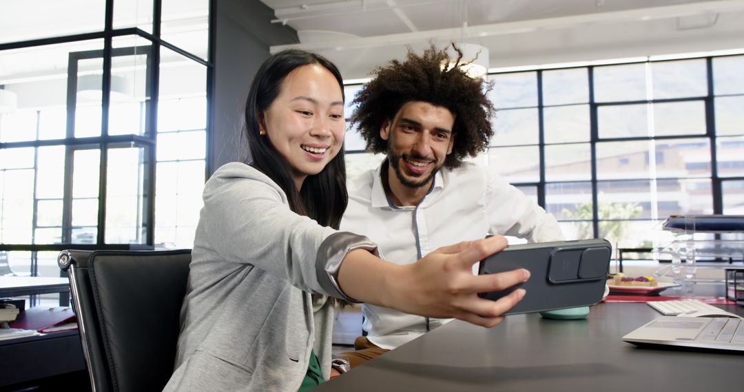 Multicultural Colleagues Smiling and Taking Selfie in Modern Office