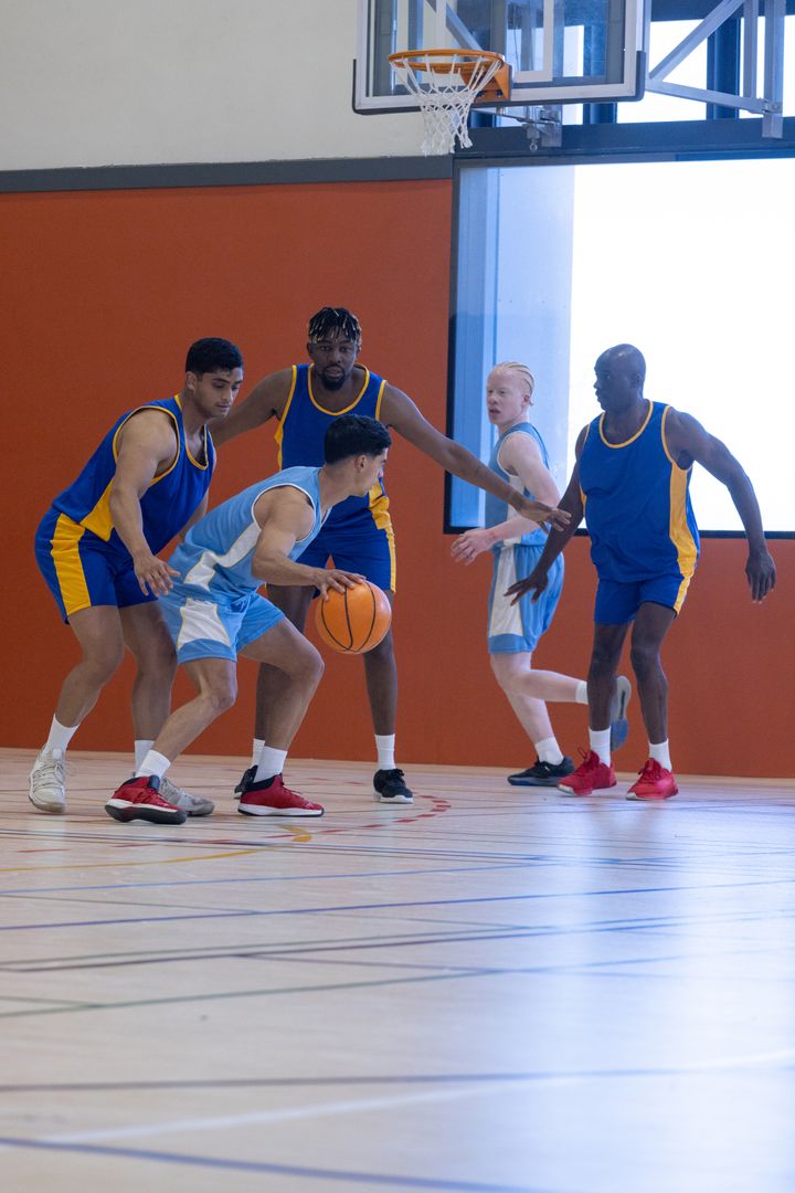 Dynamic Basketball Players Dribbling and Defending on Indoor Court