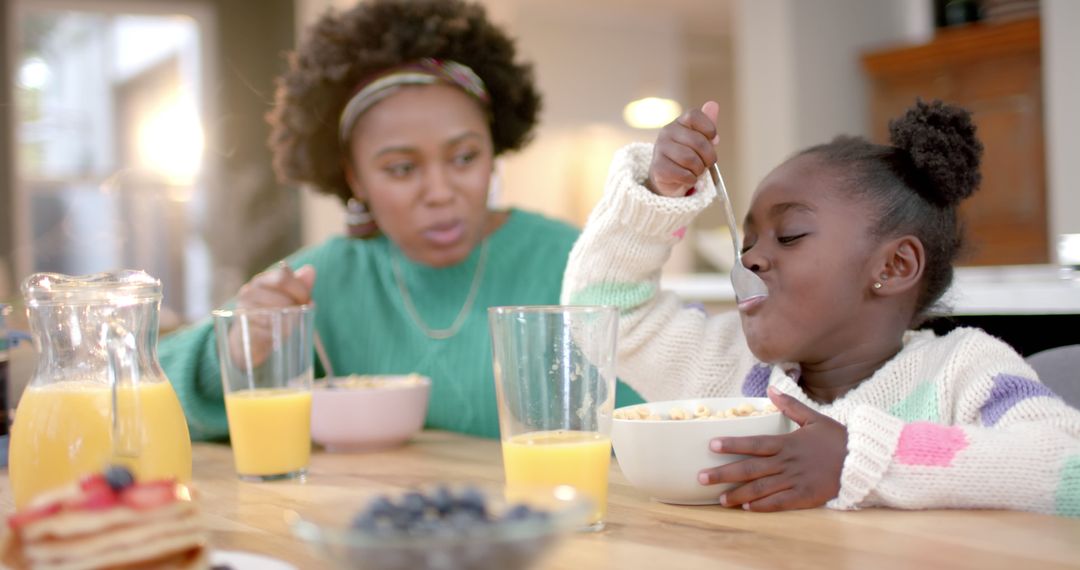 Mother and Daughter Enjoying Breakfast Together at Home - Free Images, Stock Photos and Pictures on Pikwizard.com