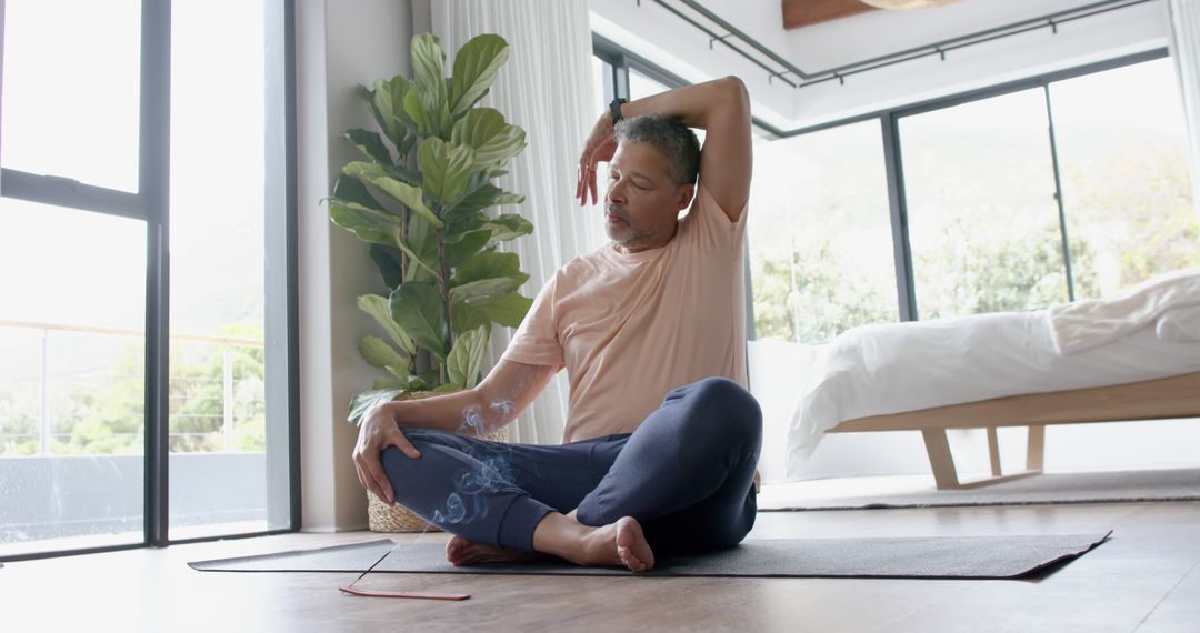 Middle-Aged Man Practicing Yoga At Home - Free Images, Stock Photos and Pictures on Pikwizard.com