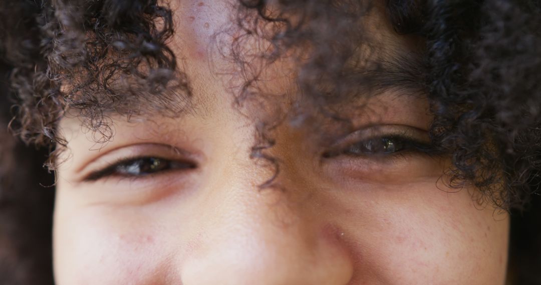 Close-up of curly hair with expressive eyes - Free Images, Stock Photos and Pictures on Pikwizard.com