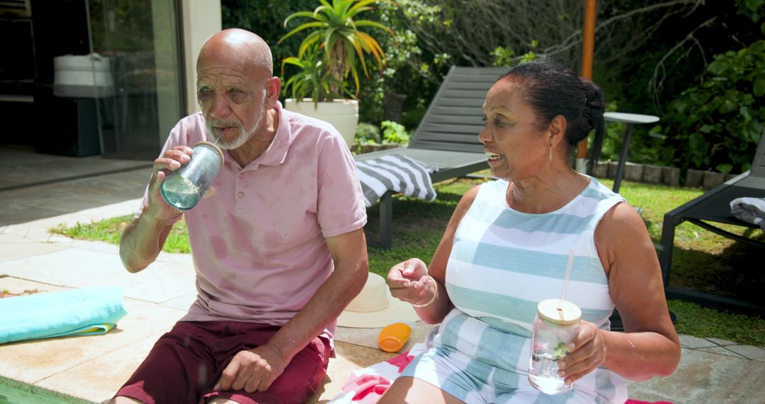 Senior Diversity Relaxation by Poolside with Drinks