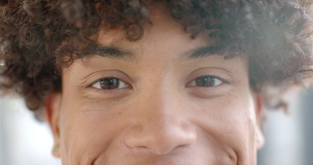 Close-Up Portrait of Curly-Haired Youth with Captivating Gaze