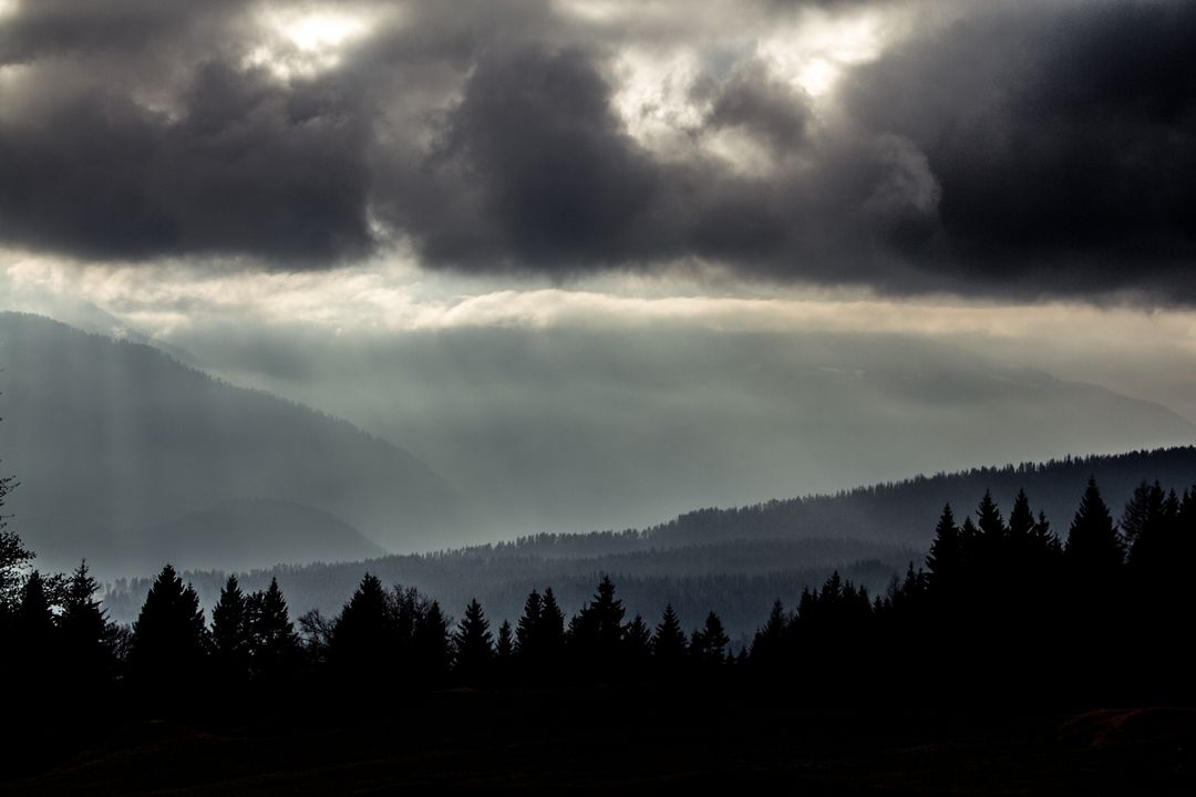 Moody Mountain Landscape with Dark Clouds and Sun Rays - Free Images, Stock Photos and Pictures on Pikwizard.com