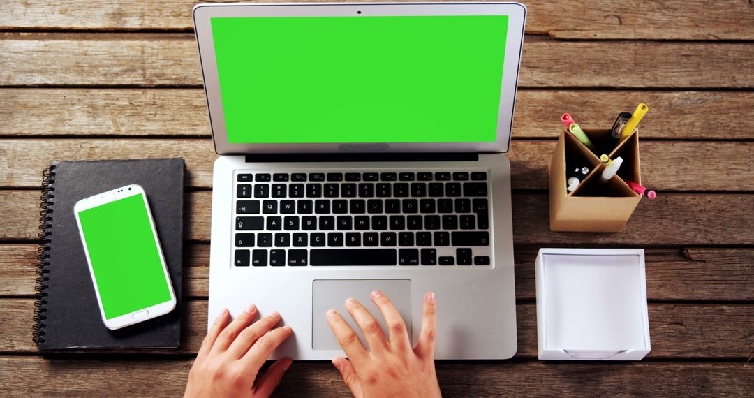 Hands Typing on Laptop with Green Screen on Wooden Desk - Free Images, Stock Photos and Pictures on Pikwizard.com