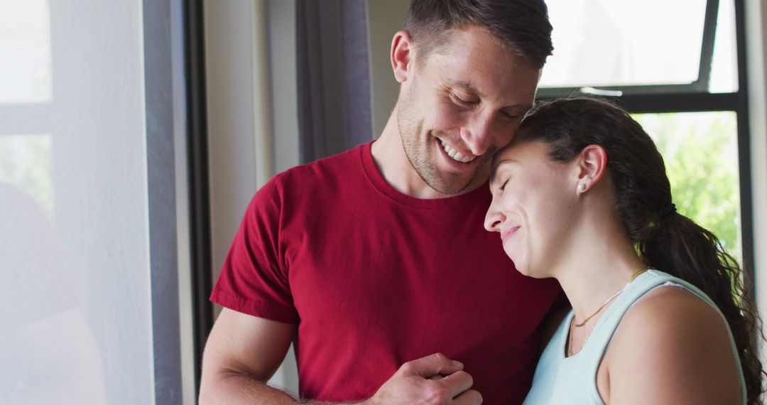Happy Couple Sharing a Serene Moment by Window
