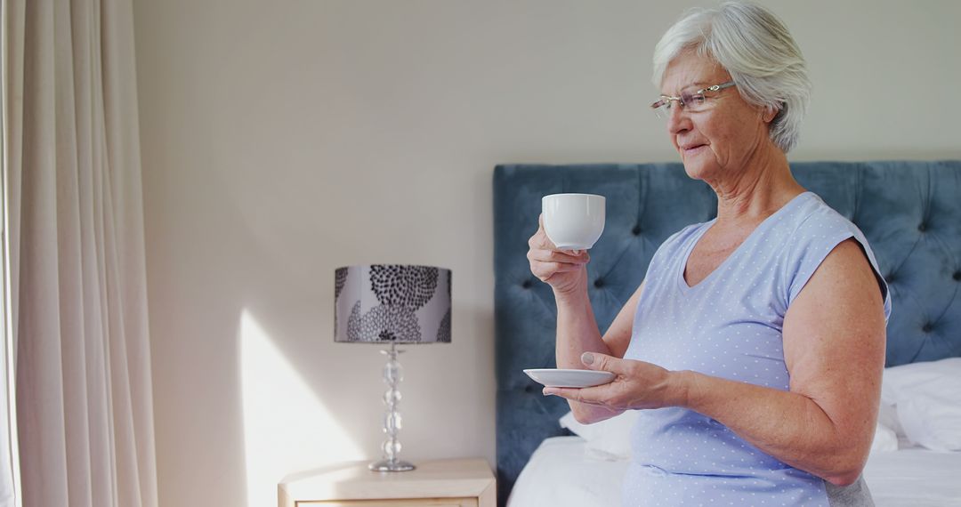 Senior Woman Drinking Coffee in Bedroom with Elegant Decor - Free Images, Stock Photos and Pictures on Pikwizard.com