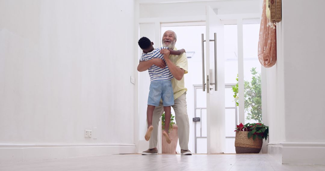 Happy Grandfather Lifting Grandson in Bright Home Entryway - Free Images, Stock Photos and Pictures on Pikwizard.com