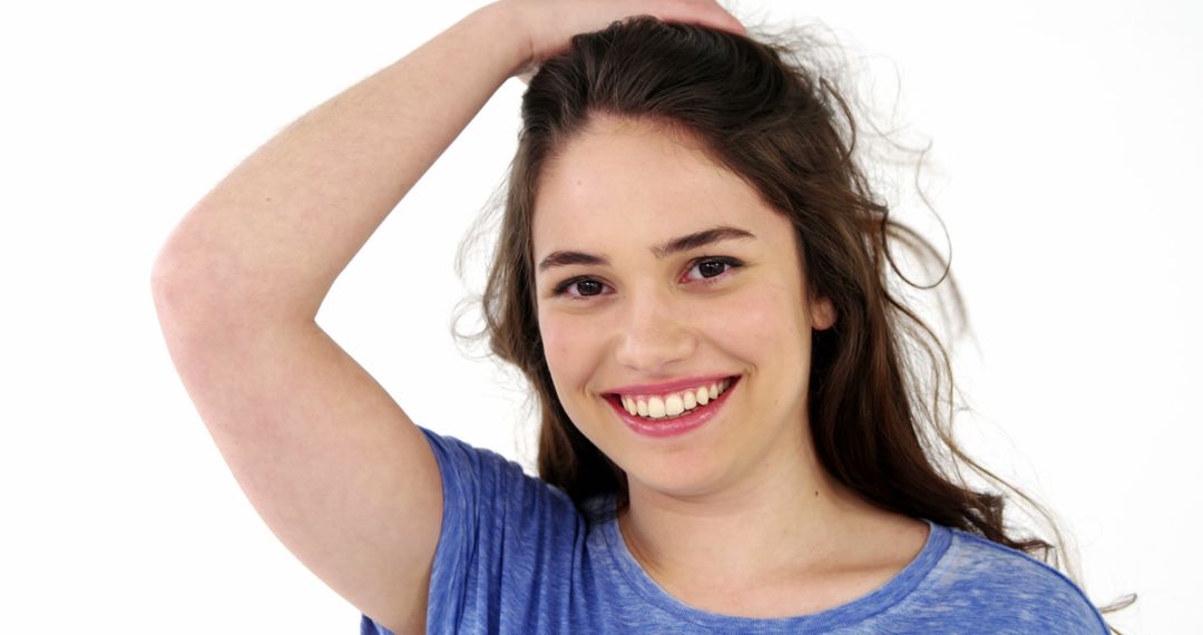 Young Woman Smiling Cheerfully with Hand on Head - Free Images, Stock Photos and Pictures on Pikwizard.com