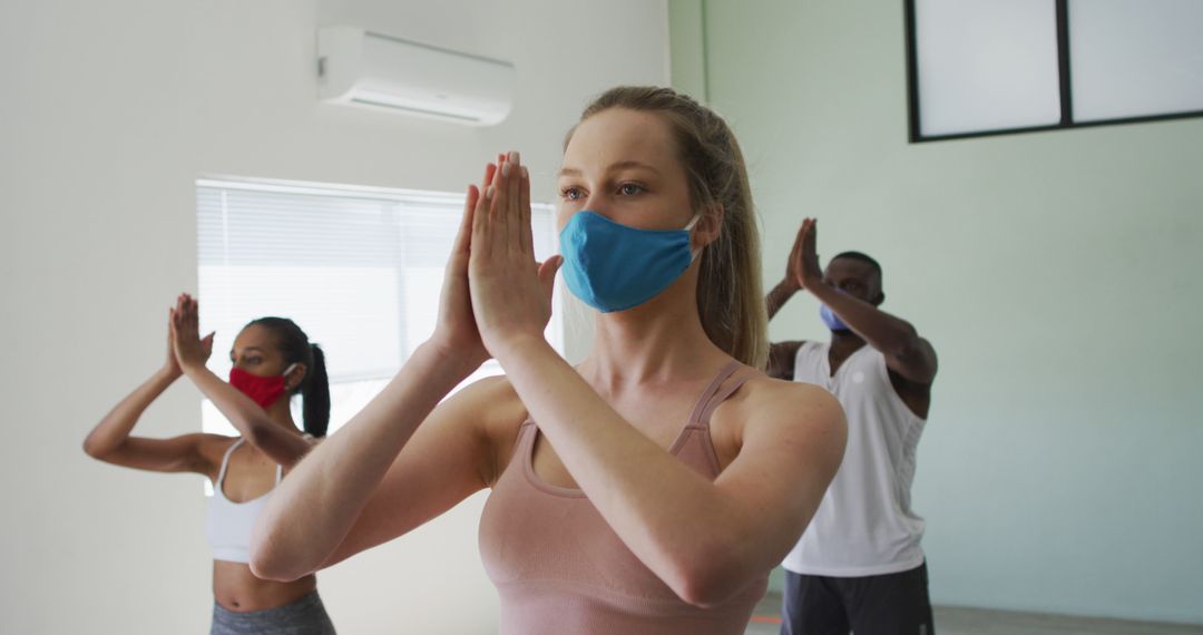 Diverse Group Practicing Yoga with Face Masks in Studio - Free Images, Stock Photos and Pictures on Pikwizard.com