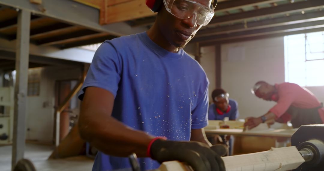 Craftsmen Shaping Wood on Lathe in Workshop