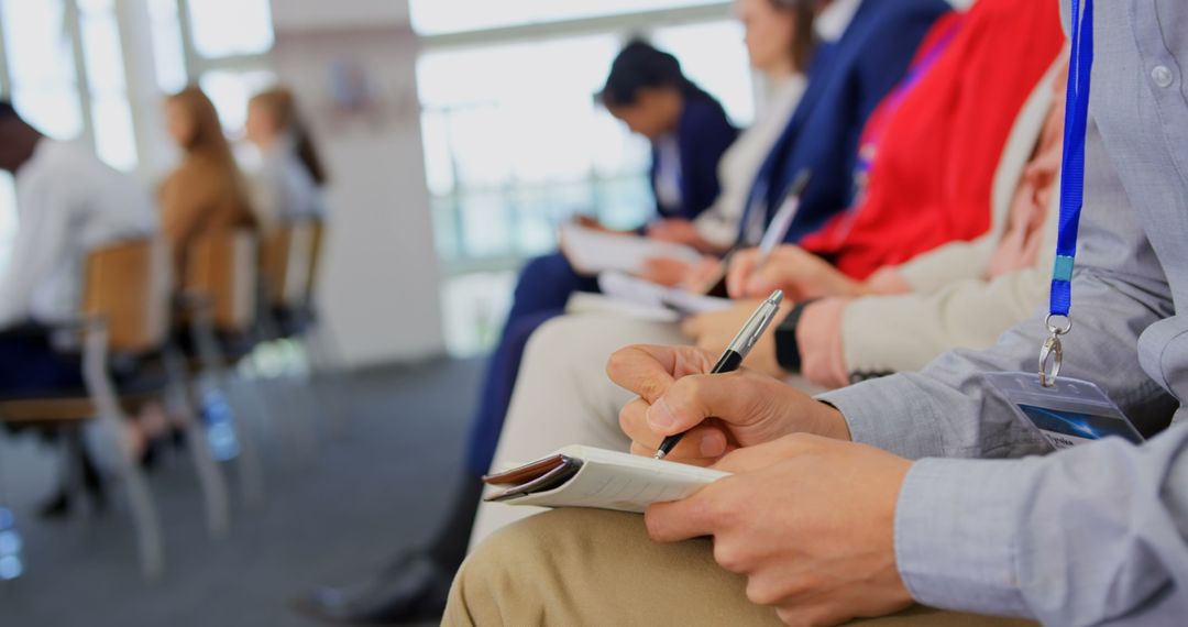 Group at Business Seminar Focused on Taking Notes