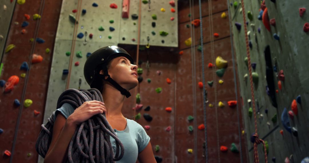 Woman Climber Preparing for Indoor Rock Climbing Session - Free Images, Stock Photos and Pictures on Pikwizard.com