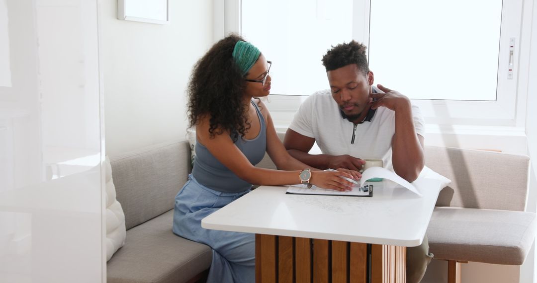 Happy Couple Collaboratively Journaling Together at Home