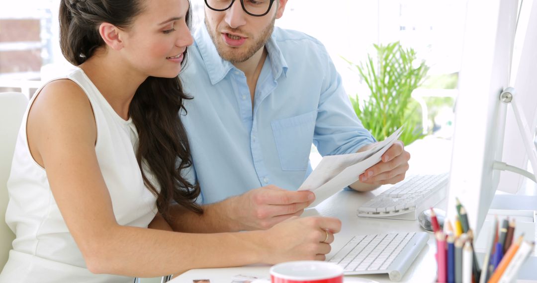 Coworkers Collaborating on Project in Office
