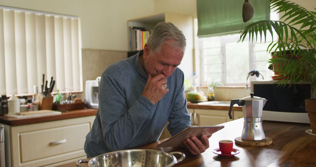 Senior Man Using Tablet in Cozy Home Kitchen - Free Images, Stock Photos and Pictures on Pikwizard.com