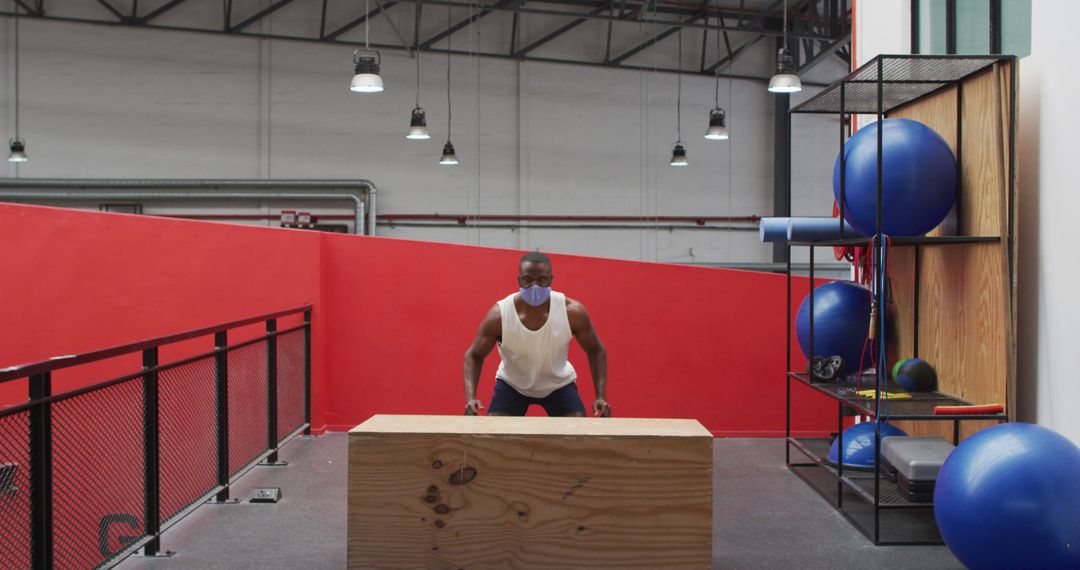 Man Exercising with Wooden Box in Industrial Fitness Gym - Free Images, Stock Photos and Pictures on Pikwizard.com