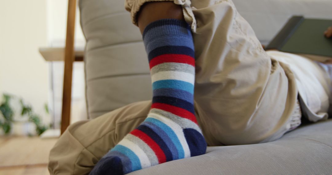 Colorful Striped Socks Relaxing on Cozy Couch