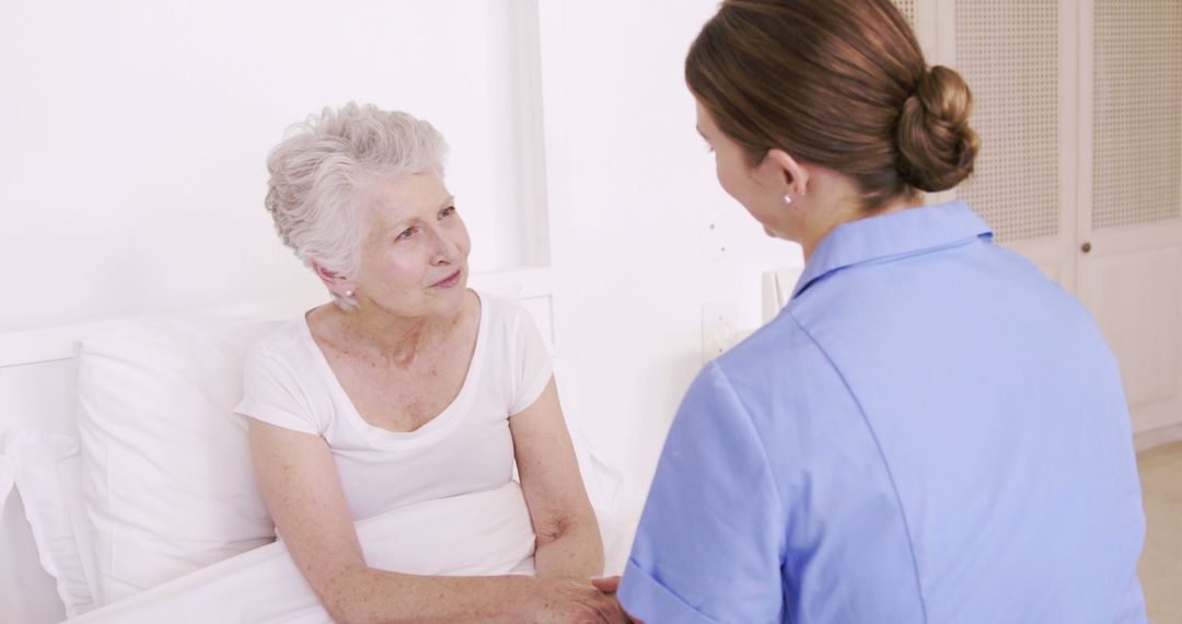 Nurse Talking to Elderly Patient in Hospital Room - Free Images, Stock Photos and Pictures on Pikwizard.com