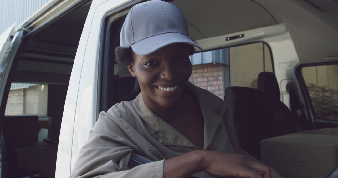 Smiling Delivery Worker in Cap Leaning on Van Door - Free Images, Stock Photos and Pictures on Pikwizard.com