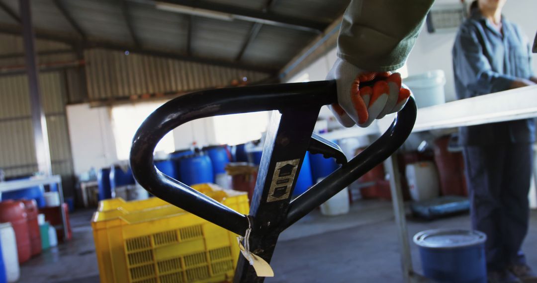 Worker Operating Pallet Jack in Industrial Warehouse - Free Images, Stock Photos and Pictures on Pikwizard.com