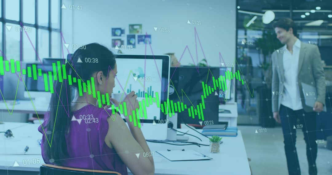 Woman Analyzing Financial Data on Office Computer Screen