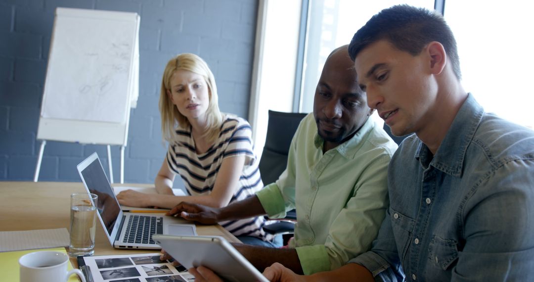 Diverse Professionals Collaborating with Digital Technology in Office