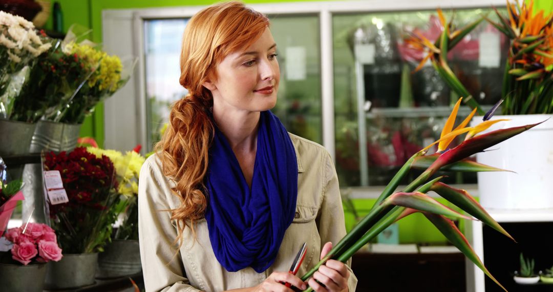 Smiling Florist Arranging Birds of Paradise at Flower Shop - Free Images, Stock Photos and Pictures on Pikwizard.com